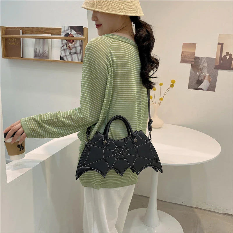 A stylish Halloween shoulder bag with a captivating spider web design, made of durable PU leather and offering ample storage space.