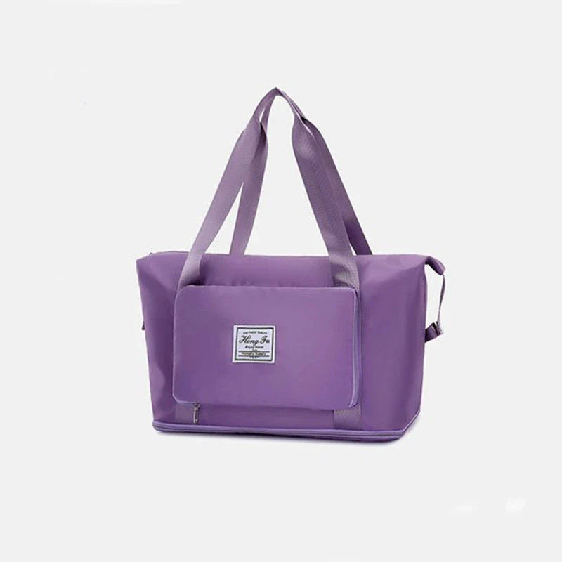 Stylish and spacious foldable travel bag for women, featuring a water-resistant Oxford cloth construction, multiple pockets, and convenient carrying options.