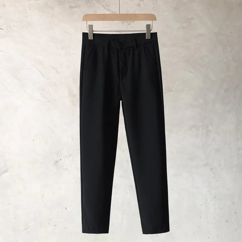 Boys slim straight wool trousers in tapered fit on hanger, showing straight leg opening.