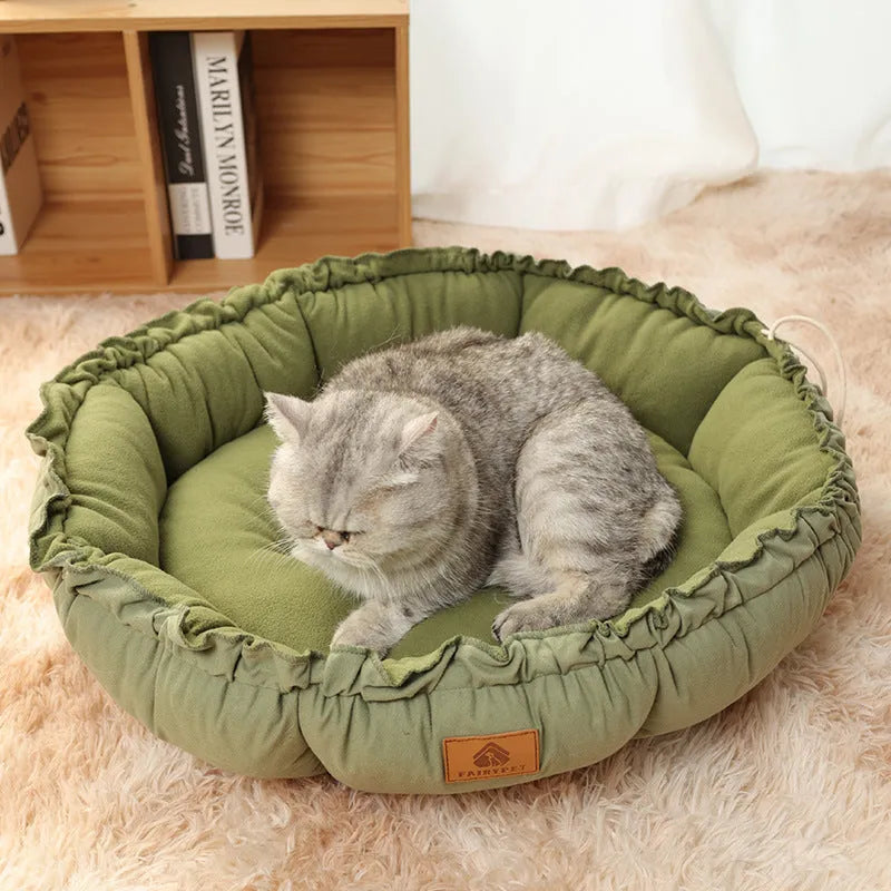 Reversible circular donut cat bed in grey and green colours showing raised outer rim