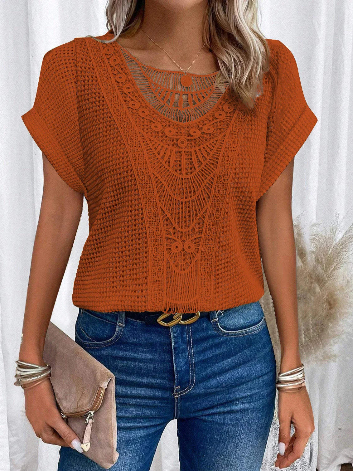 A stylish and comfortable short-sleeve t-shirt for women, featuring a unique hollowed-out design and breathable polyester fabric.