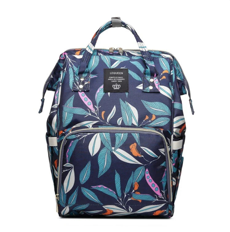 Stylish maternity diaper bag in various colors, featuring a paper bag design, separate bottle compartment, and discreet breastfeeding button.