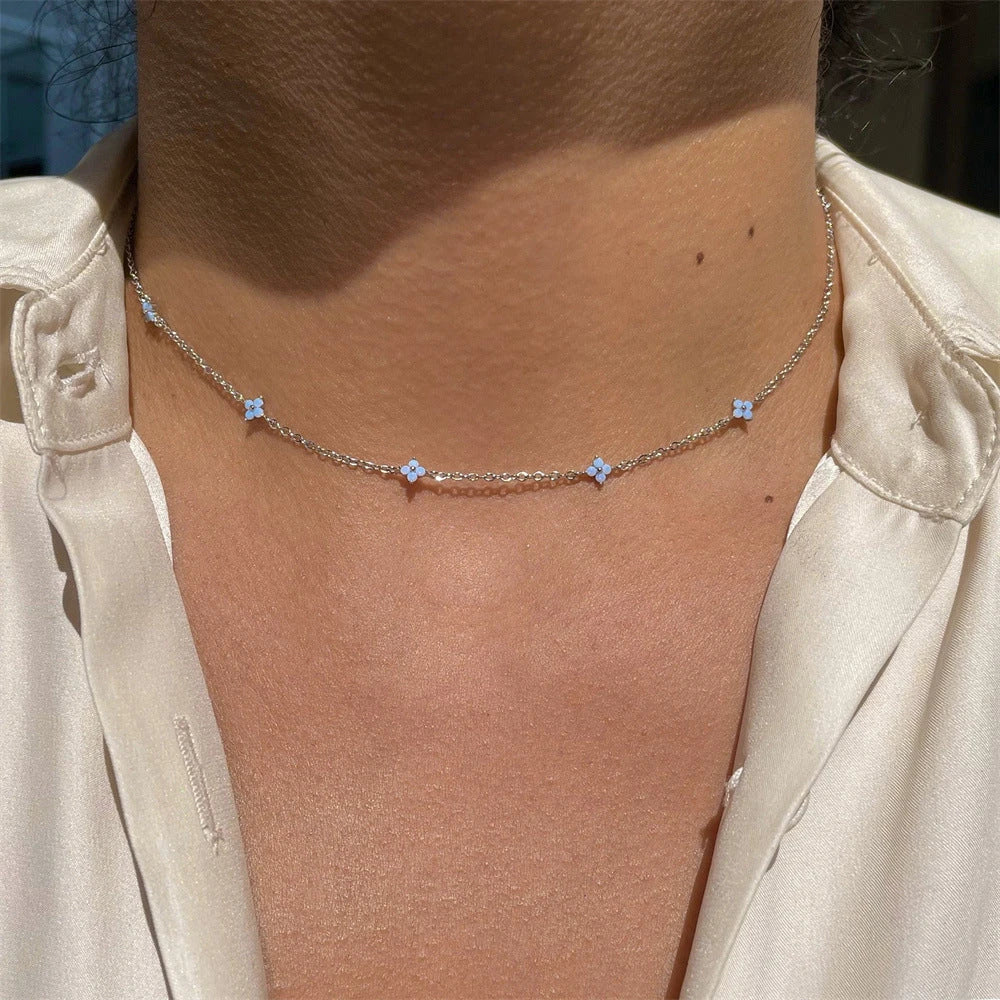 Elegant gold and silver floral necklace with adjustable chain and flower charm, perfect for vacation and beach outfits