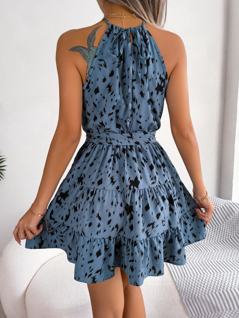 Leopard print ruffled swing dress in various colors, including khaki, white, and blue, with a flattering A-line silhouette and delicate ruffled details