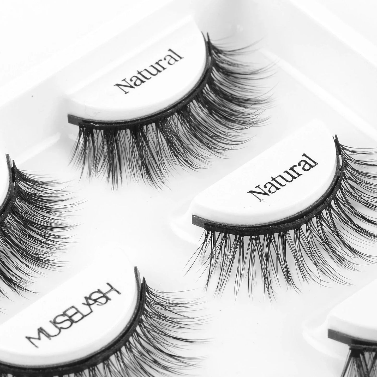 Magnetic false eyelashes in various styles, including cross, thick, feathery, natural slim, and elongated, with a liquid eyeliner pen