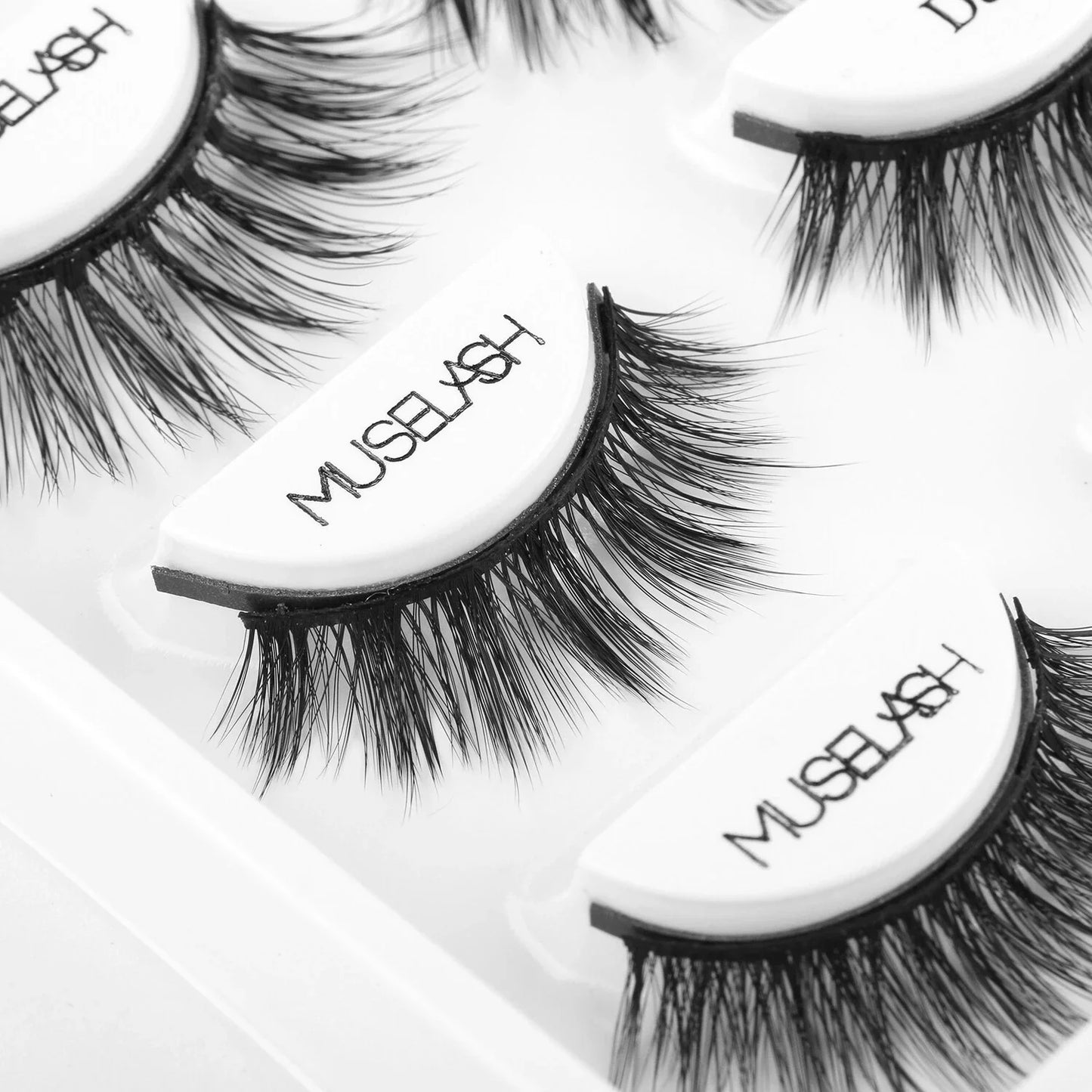 Magnetic false eyelashes in various styles, including cross, thick, feathery, natural slim, and elongated, with a liquid eyeliner pen