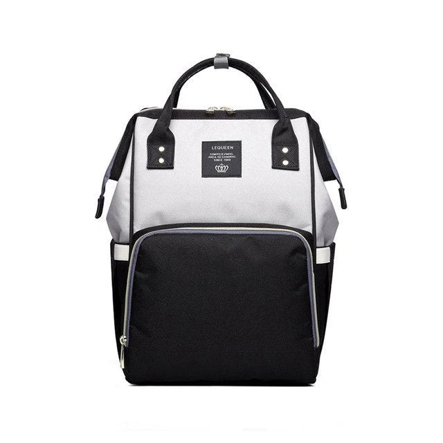 Stylish maternity diaper bag in various colors, featuring a paper bag design, separate bottle compartment, and discreet breastfeeding button.