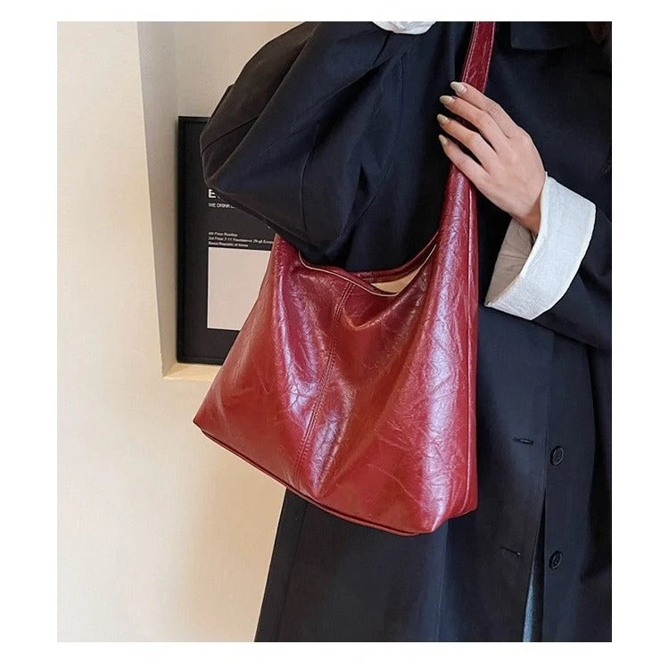 Classic vintage-inspired women's shoulder bag in a range of sophisticated colours, featuring a roomy interior, adjustable strap, and premium materials for timeless British style.