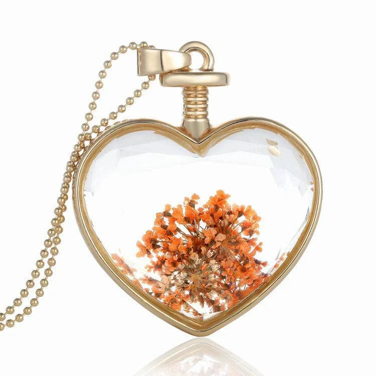 Elegant floral pendant necklace with a dried flower charm on a gold-tone chain