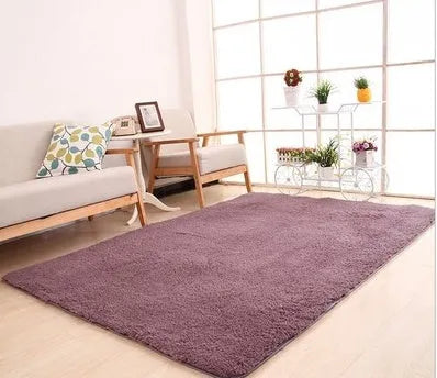 Solid colour plush rectangle area rug with soft texture on a wooden floor.