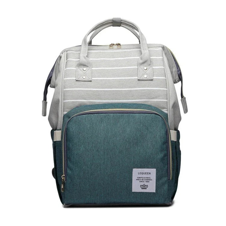 Stylish maternity diaper bag in various colors, featuring a paper bag design, separate bottle compartment, and discreet breastfeeding button.