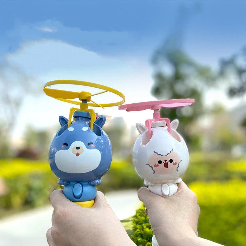 Charming bamboo dragonfly bubble machine toy with colourful bubbles floating in the air, perfect for outdoor playtime and parties