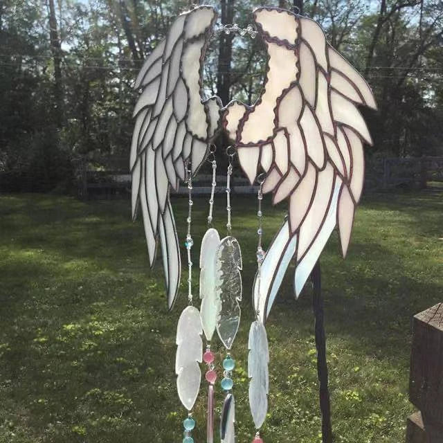 Stunning acrylic and metal angel wing chime suncatcher with sparkling crystal and glass accents, designed to bring a sense of peace and enchantment to your home or garden
