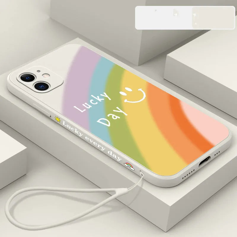Rainbow smiley silicone phone case for iPhone in blue, showing all-inclusive design and back cover detail.