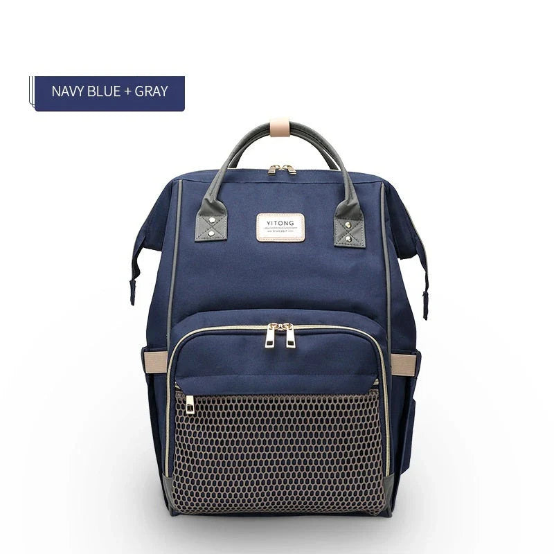 Stylish maternity diaper bag in various colors, featuring a paper bag design, separate bottle compartment, and discreet breastfeeding button.