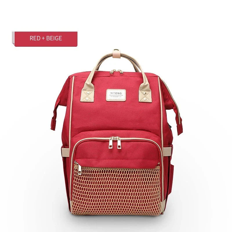 Stylish maternity diaper bag in various colors, featuring a paper bag design, separate bottle compartment, and discreet breastfeeding button.
