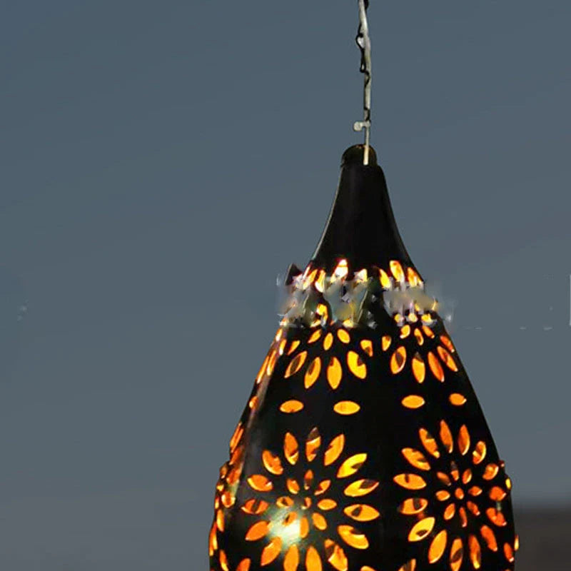 Elegant solar-powered garden lantern with a drop-shaped metal design and a soft, flower-patterned glow