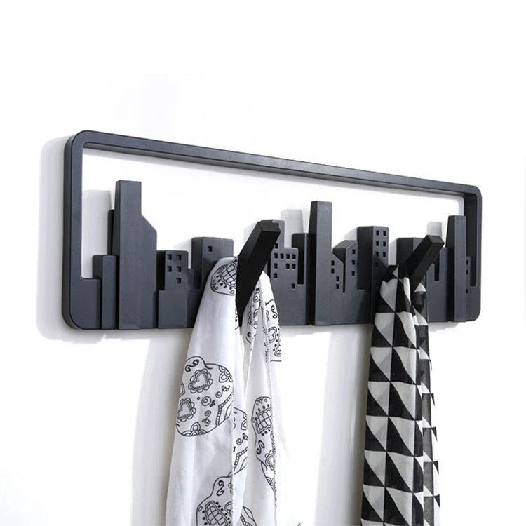 Wall-mounted coat rack with five flip-down hooks for organizing coats, hats, and other accessories