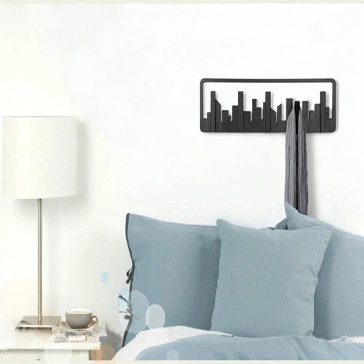Wall-mounted coat rack with five flip-down hooks for organizing coats, hats, and other accessories