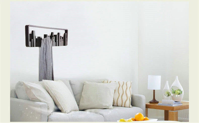 Wall-mounted coat rack with five flip-down hooks for organizing coats, hats, and other accessories