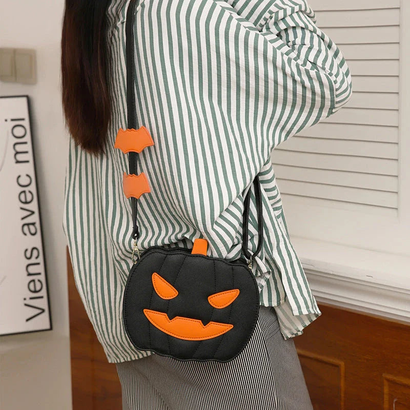 Pumpkin cartoon shoulder bag with adjustable strap and roomy interior, available in various Halloween-inspired colors