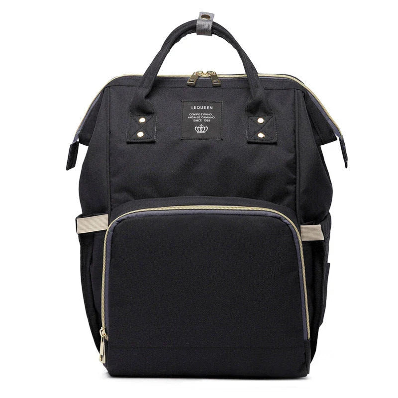 Stylish maternity diaper bag in various colors, featuring a paper bag design, separate bottle compartment, and discreet breastfeeding button.