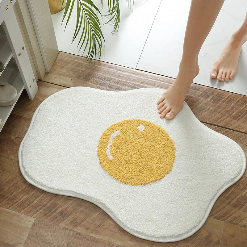 Stylish and absorbent egg-shaped doormat in various sizes and colors, made of plush polyester with a non-slip rubber backing