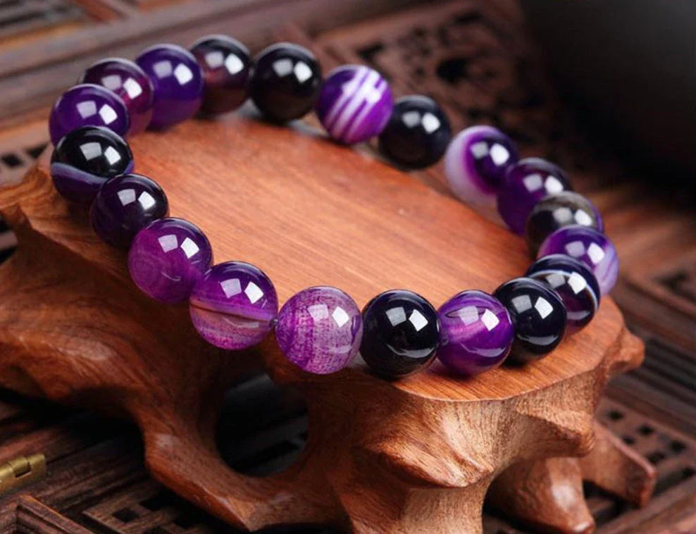 Handcrafted beaded bracelet with seven chakra-representing beads, designed to promote balance and well-being.