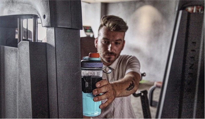 Magnetic water bottle holder in black, blue, and green colors, featuring a silicone cup that can securely attach to any metal surface.