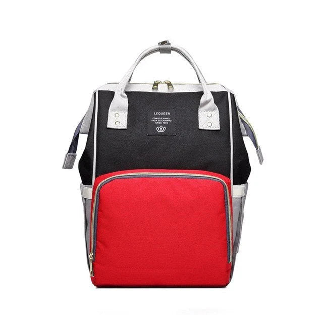 Stylish maternity diaper bag in various colors, featuring a paper bag design, separate bottle compartment, and discreet breastfeeding button.