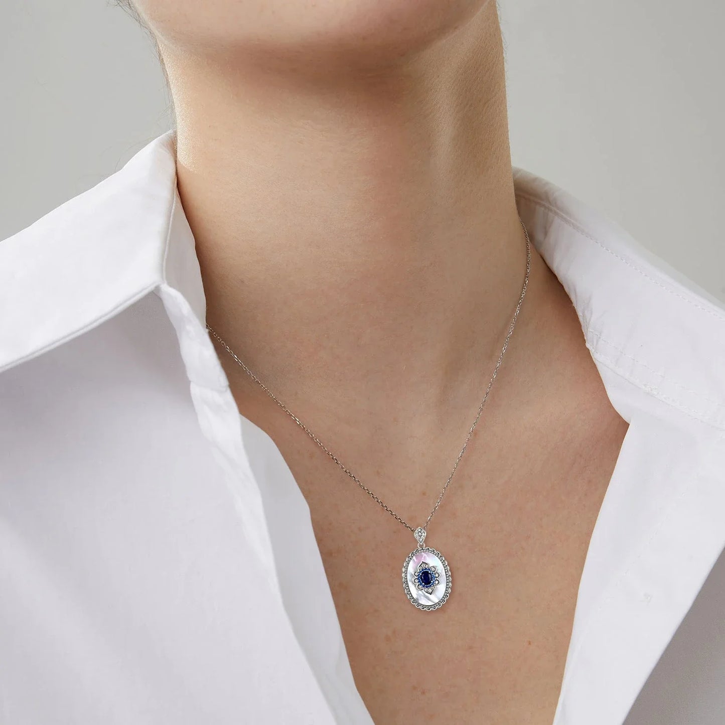 Elegant sapphire and diamond pendant necklace in 925 sterling silver, featuring a sparkling gemstone design and adjustable chain.