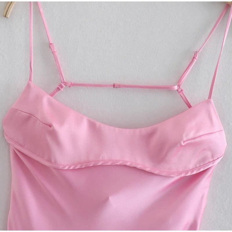 Elegant satin slip dress in pink with a square neckline, sleeveless design, and backless detail