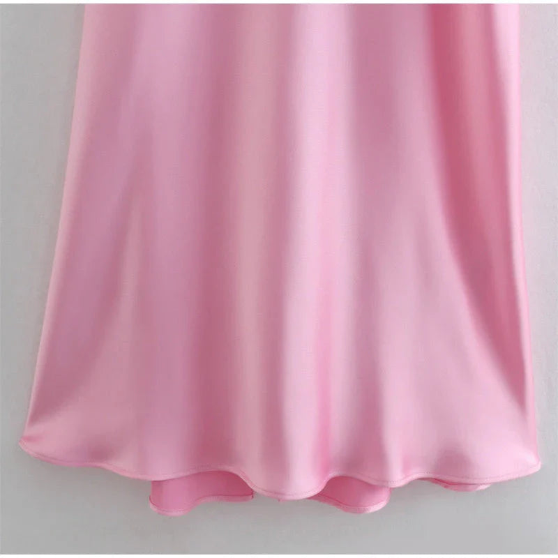 Elegant satin slip dress in pink with a square neckline, sleeveless design, and backless detail