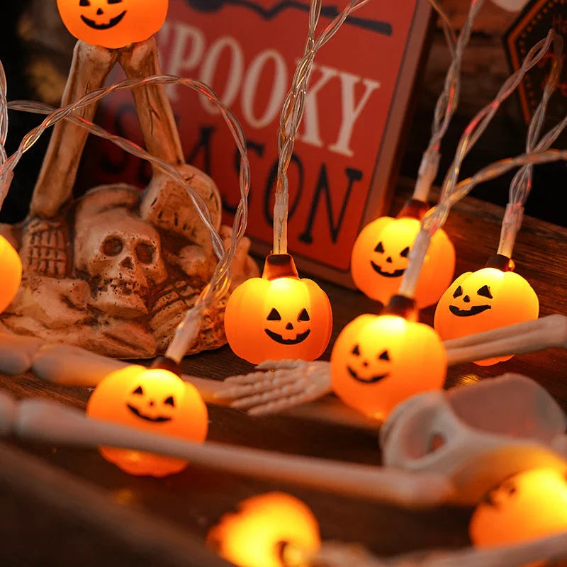 Battery-powered LED Halloween lights in various spooky designs including pumpkins, ghosts, and bats with warm white glow