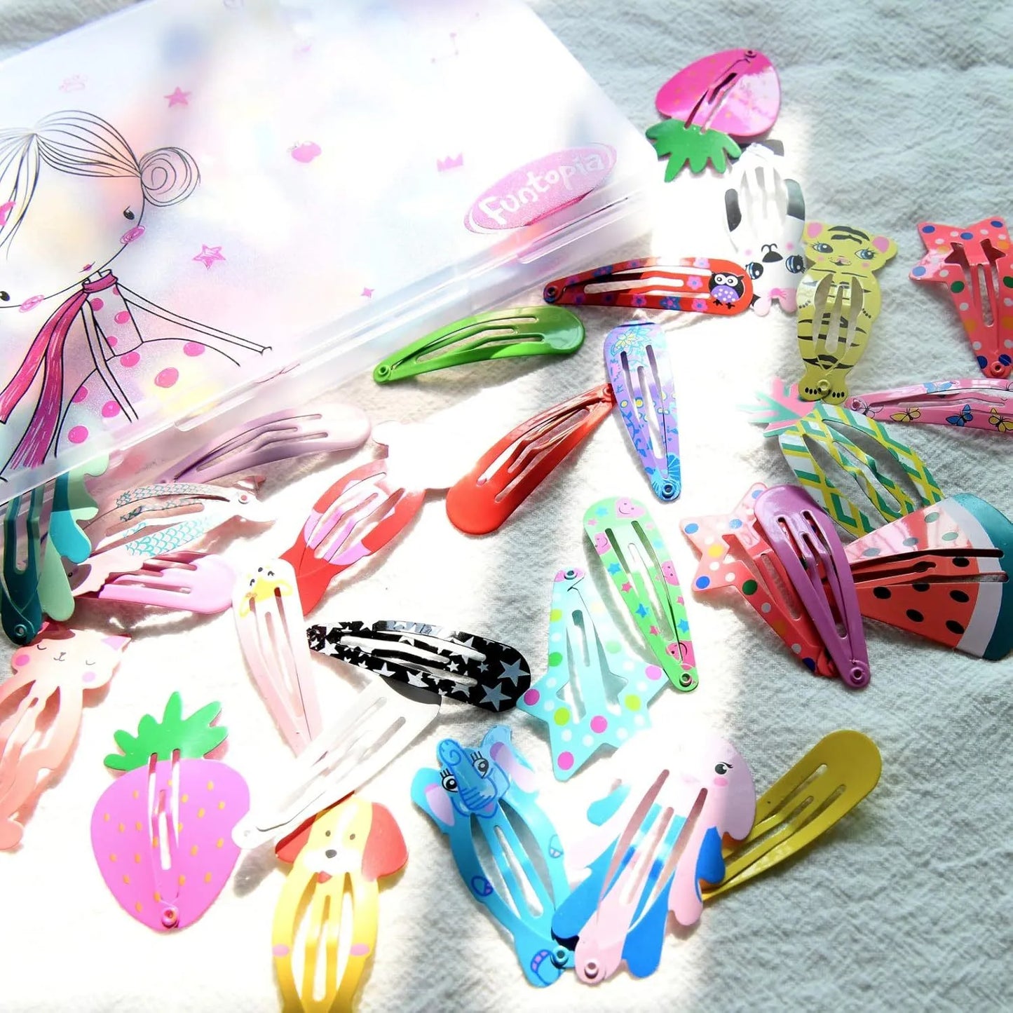 Assortment of 100 hair clips with cartoon designs including animals, fruits, crowns and stars in bright colours