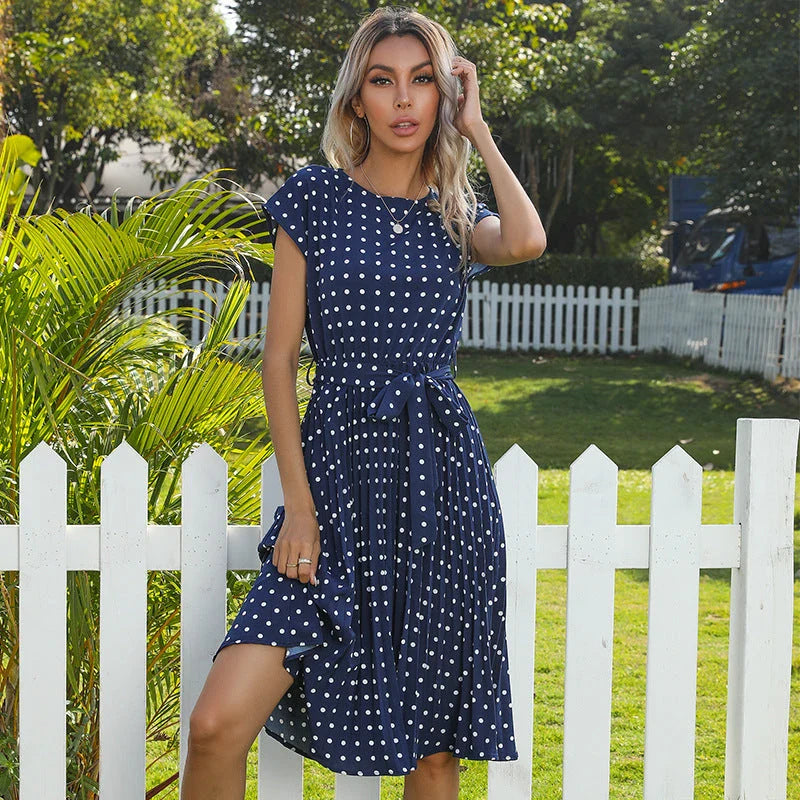 A classic polka dot midi dress with a buttoned style, perfect for summertime