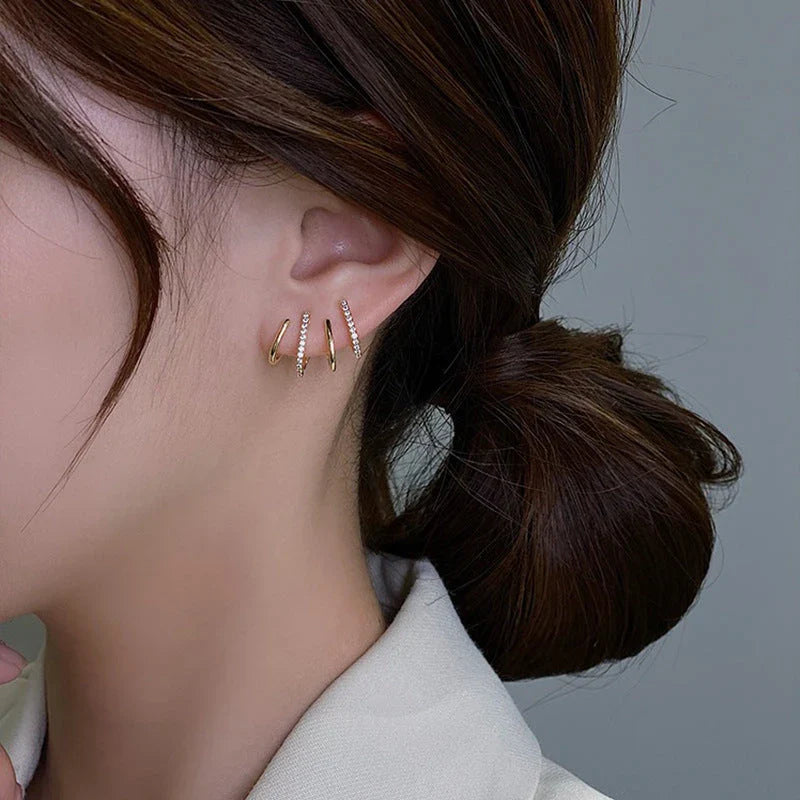 Pair of 925 sterling silver earrings with four-prong zircon stone settings in a geometric design
