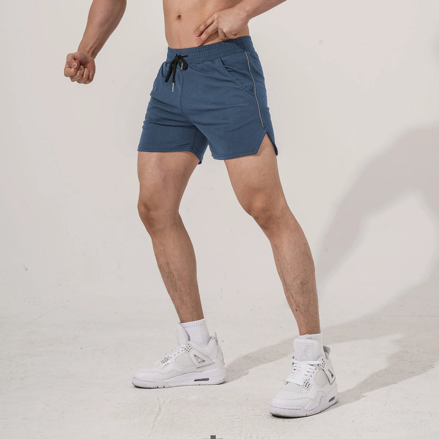 Men's black polyester sports casual shorts with a straight-leg cut on a grey background.