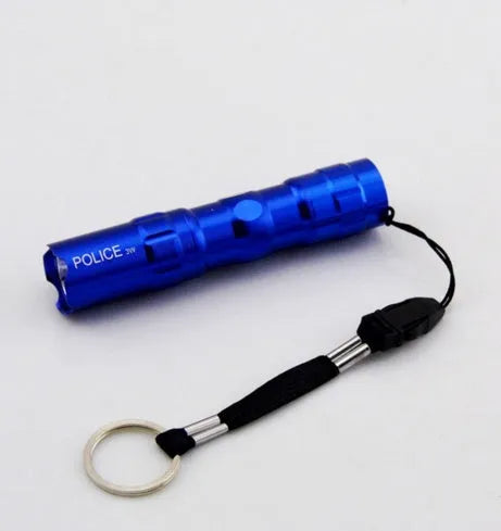 Black aluminium mini LED flashlight shown next to a AA battery for scale.