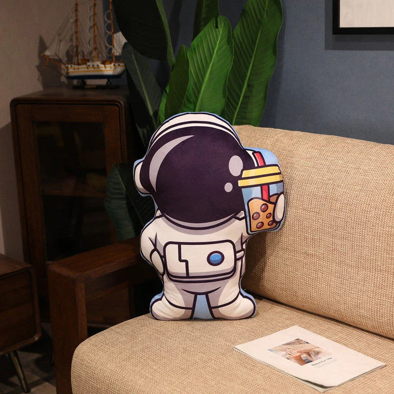 Soft plush astronaut pillows in various space-themed designs, including rockets, spacecraft, and more