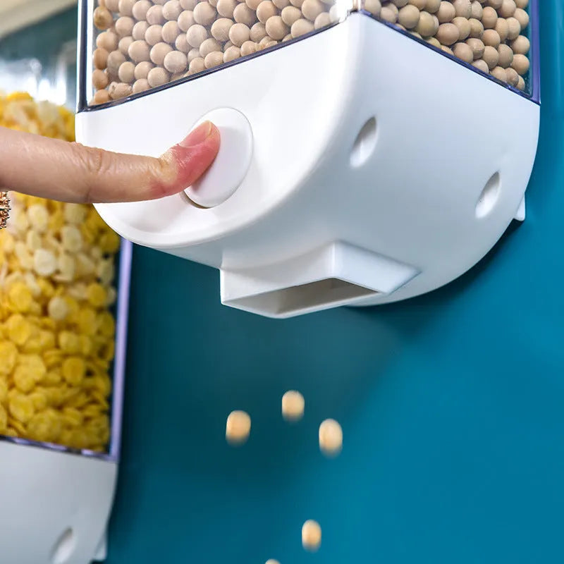 White wall-mountable kitchen food storage box with press lid dispenser, showing transparent body with cereal inside.
