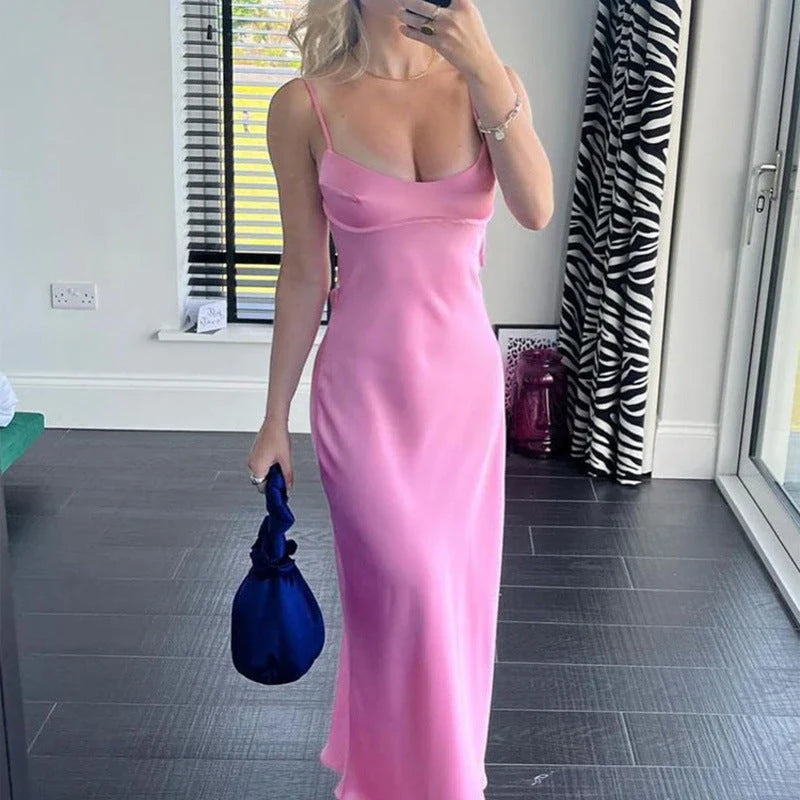Elegant satin slip dress in pink with a square neckline, sleeveless design, and backless detail
