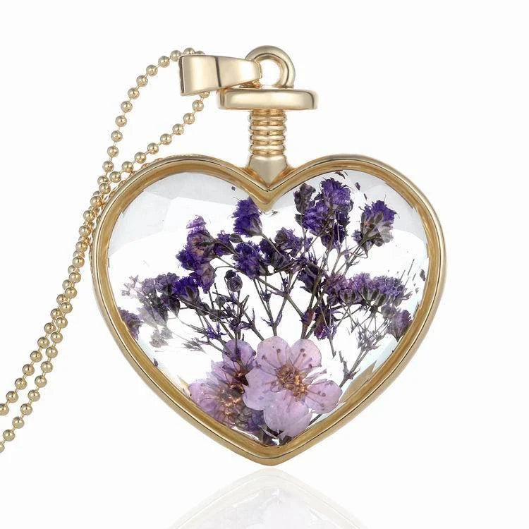 Elegant floral pendant necklace with a dried flower charm on a gold-tone chain