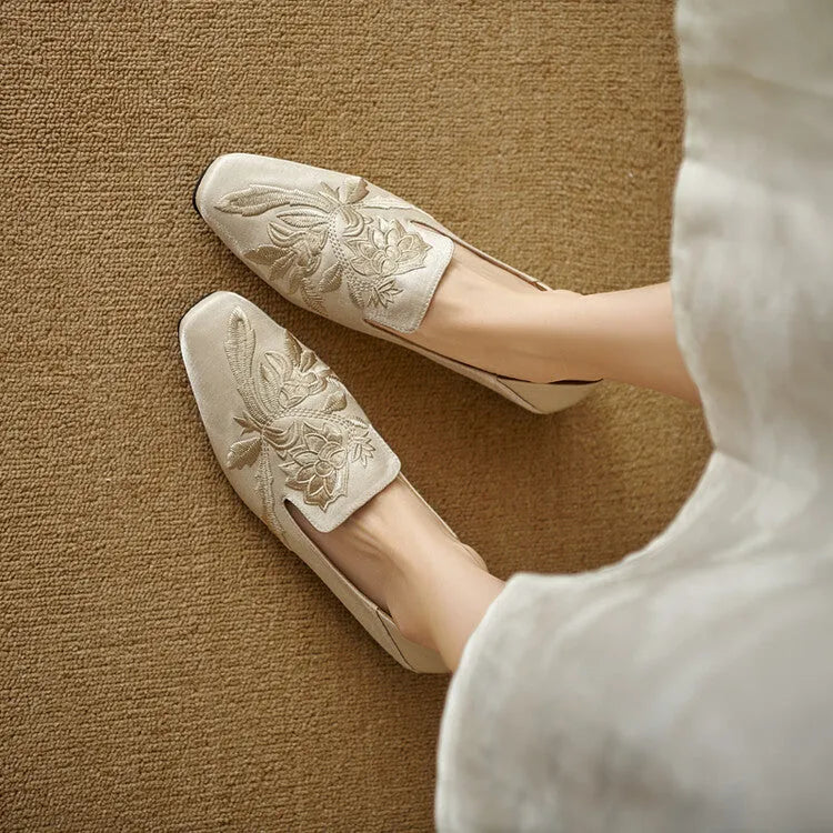 Women's embroidered low-cut flat pumps in beige with a round toe and soft sole.
