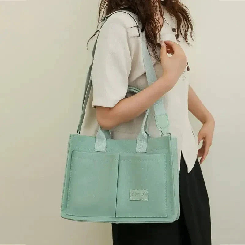 Premium canvas tote bag with multiple pockets, adjustable shoulder strap, and stylish design for everyday use