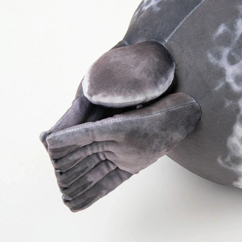 A plush, lifelike seal cushion in various sizes and colours, made of soft velvet fabric and PP cotton filling