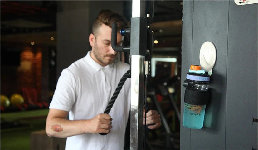 Magnetic water bottle holder in black, blue, and green colors, featuring a silicone cup that can securely attach to any metal surface.