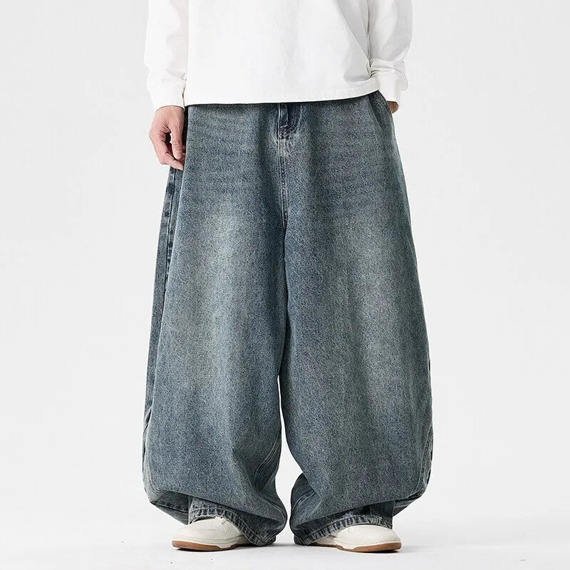 Men's plus-size light blue wide-leg baggy jeans on a neutral background.