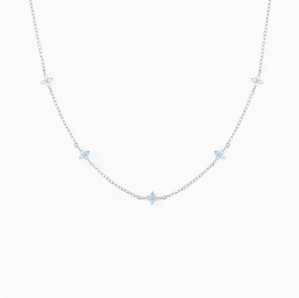 Elegant gold and silver floral necklace with adjustable chain and flower charm, perfect for vacation and beach outfits