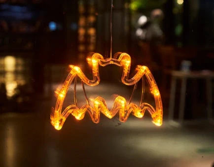Spooky Halloween window lights featuring ghostly silhouettes, carved pumpkins, and creepy spiders for festive seasonal decor